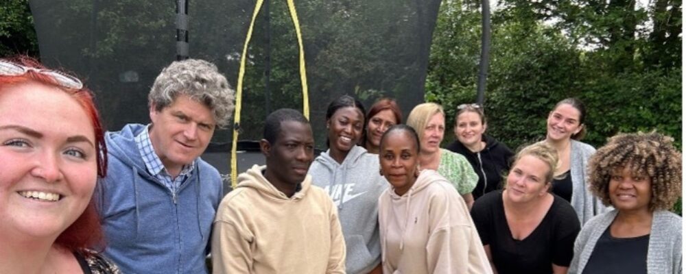 Group photo with residents at mental health support care home - Applewood Healthcare