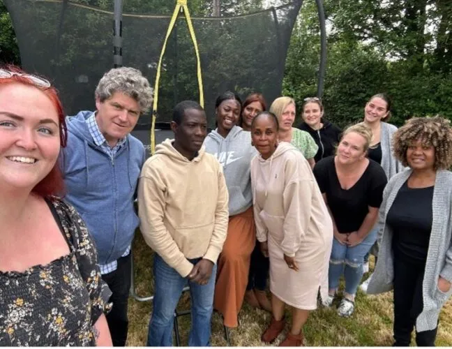 Group photo with residents at mental health support care home - Applewood Healthcare