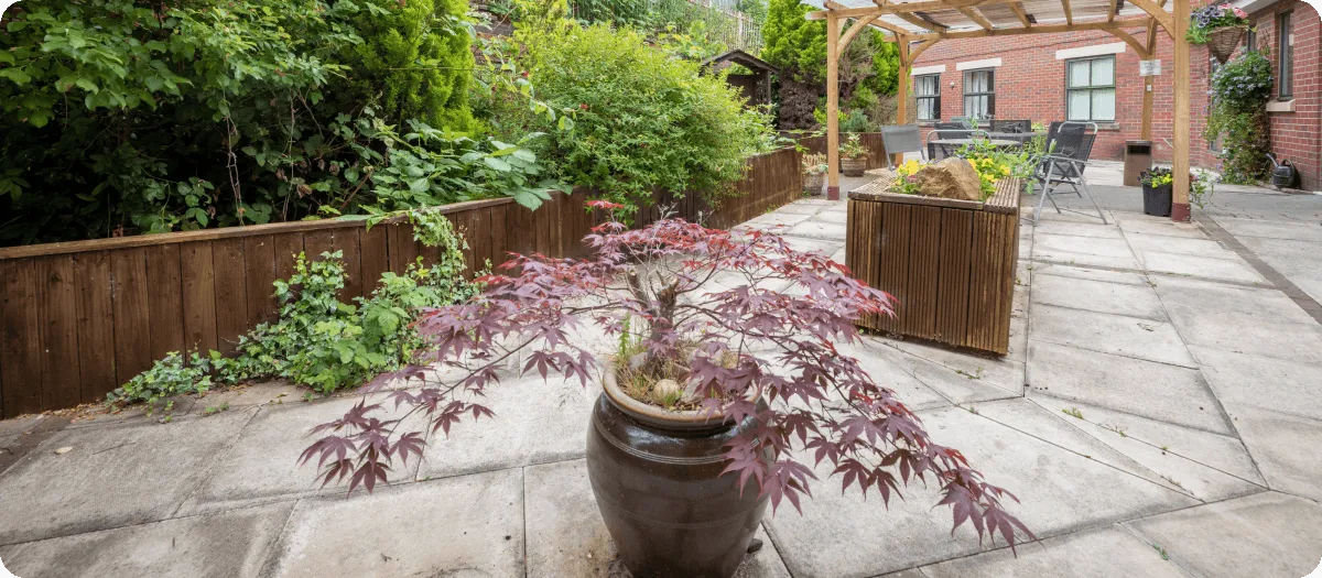 Patio outdoor exercise area with plants - Applewood Healthcare