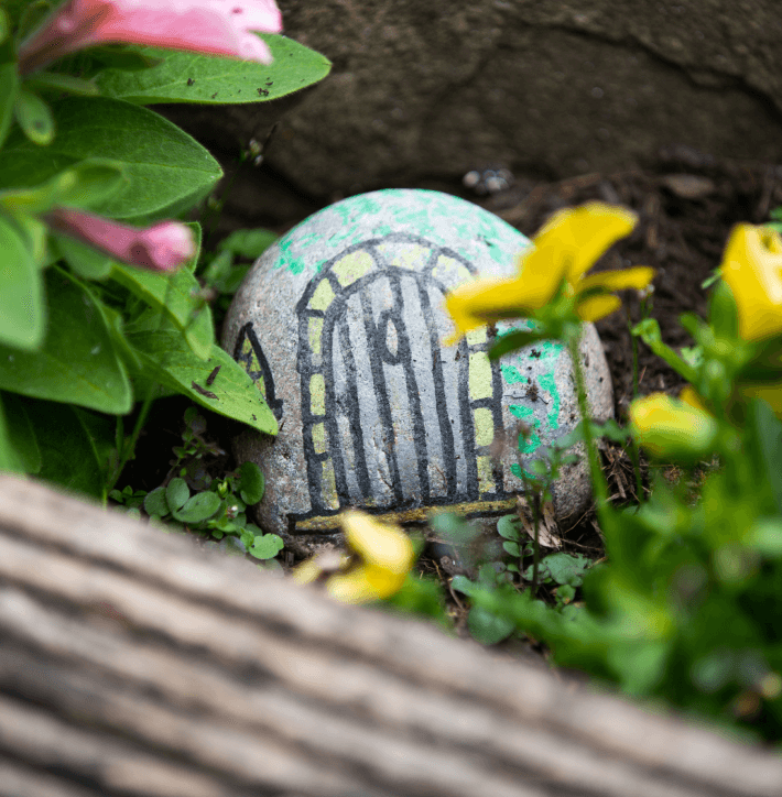 A painted rock in the garden - Applewood Healthcare