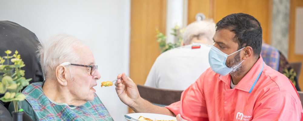 Nurse feeding an elderly resident - Applewood Healthcare