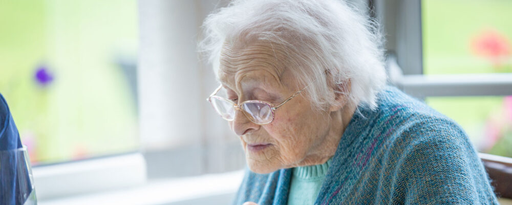 Elderly lady eating breakfast at Cherry Grove care home - Applewood Healthcare